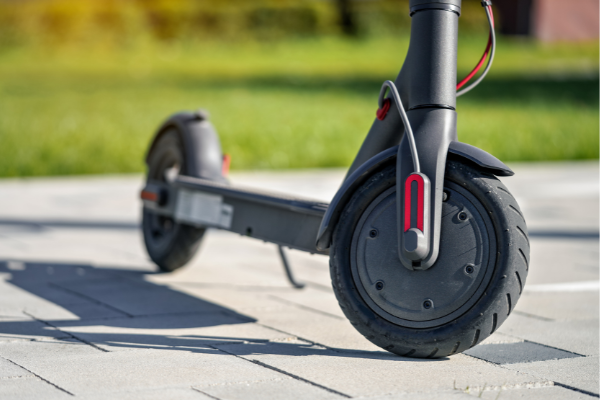 Closeup view of an electric scooter parked on a stone pavement