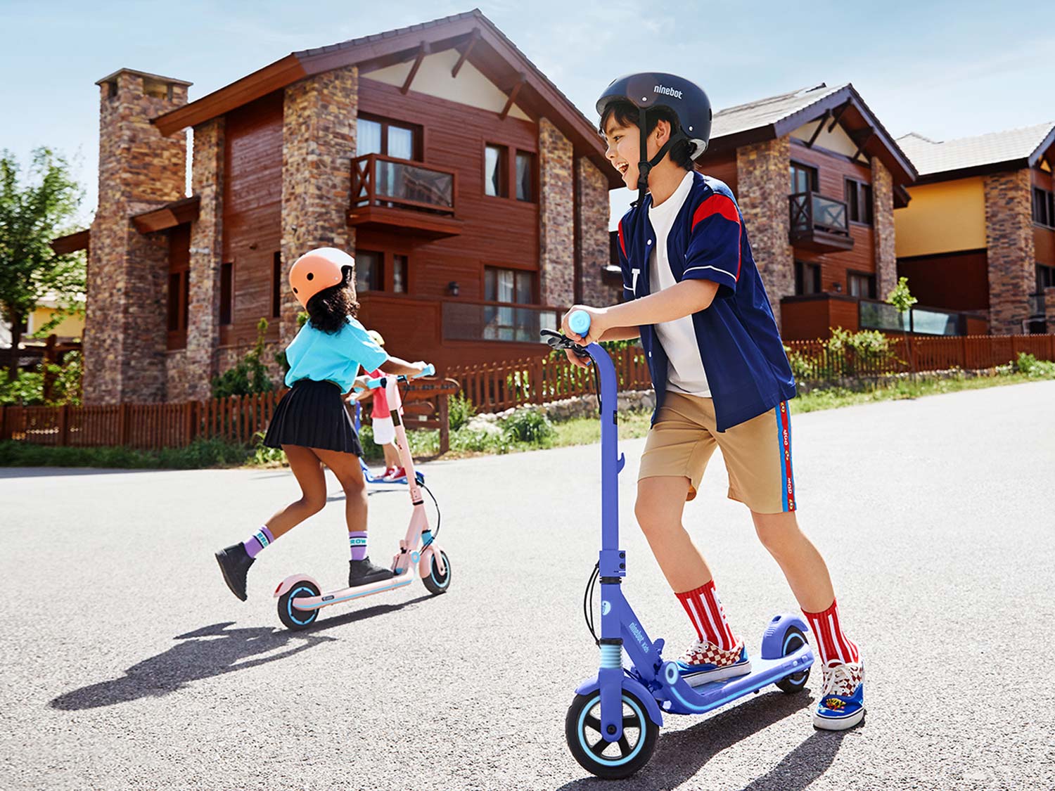 2 kids riding Ninebot Scooter in the street