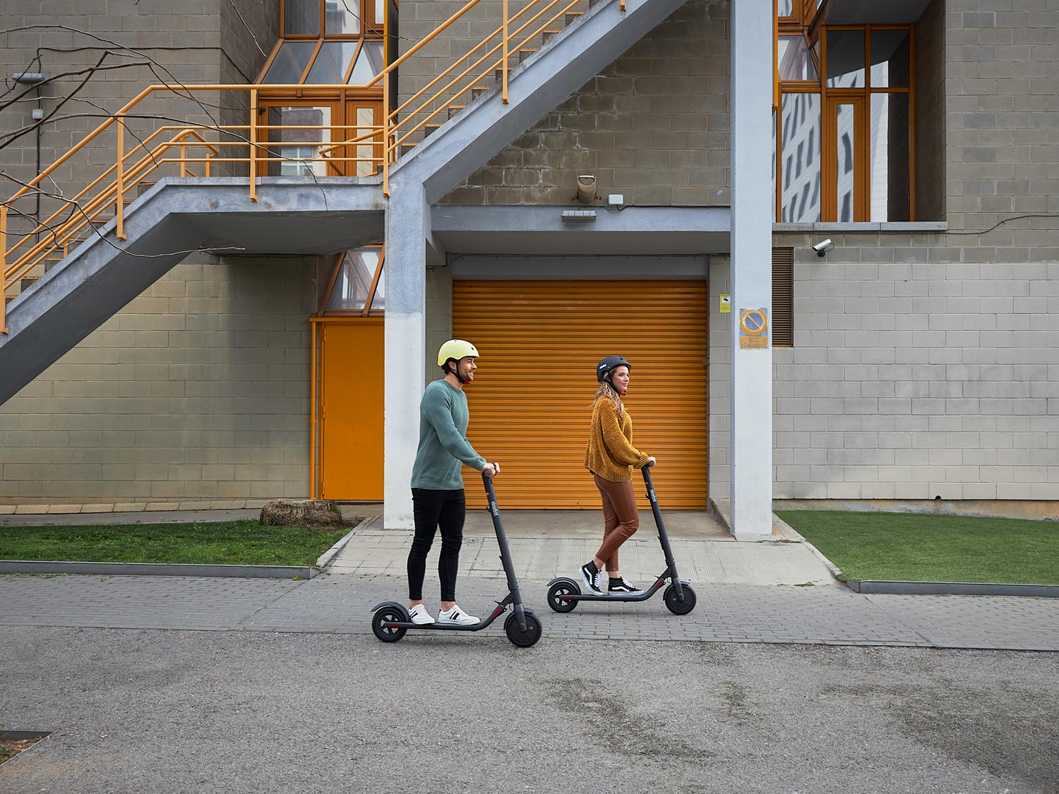 man and a woman riding a Segway Ninebot scooter