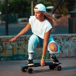 Woman riding an electric longboard in the park