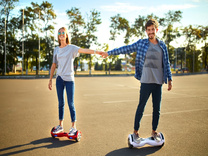 couple riding electric hoverboard