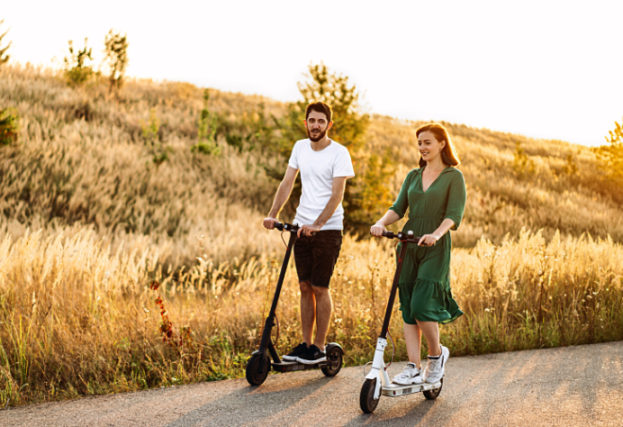 Couple riding electric scooters at the countryside road - My Electric Scooter