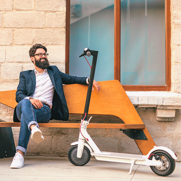 Man sitting on a wooden bench and a white Electric Scooter - My Electric Scooter