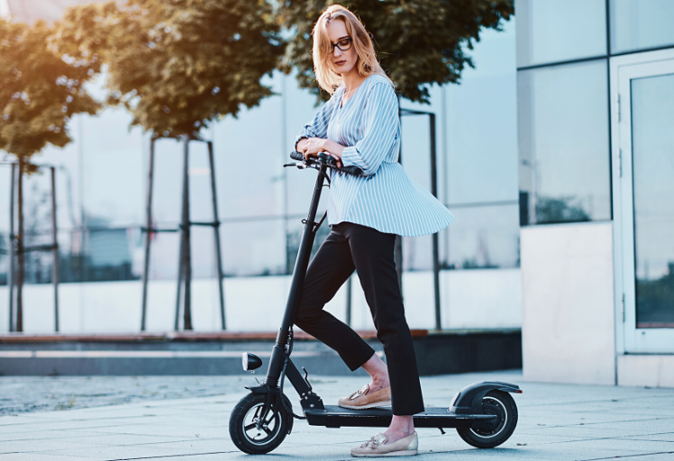 Stylish woman riding electric scooter - My Electric Scooter