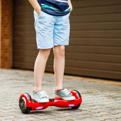 Person wearing blue shorts and T-shirt with blue shoes riding Self Balancing Electric Hoverboard - My Electric Scooter
