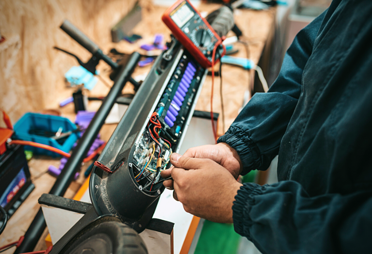 Technician repairing an electric scooter