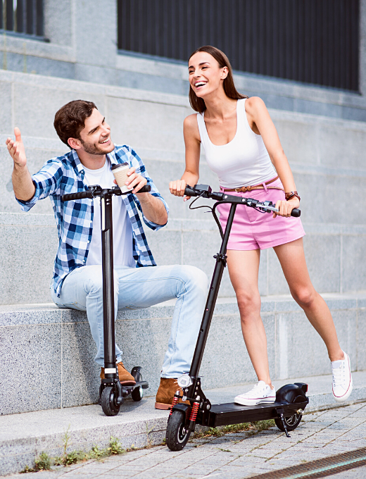 Couple having fun with electric scooters