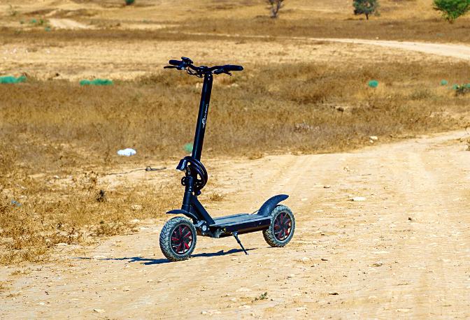 An electric scooter parked on a dirt road